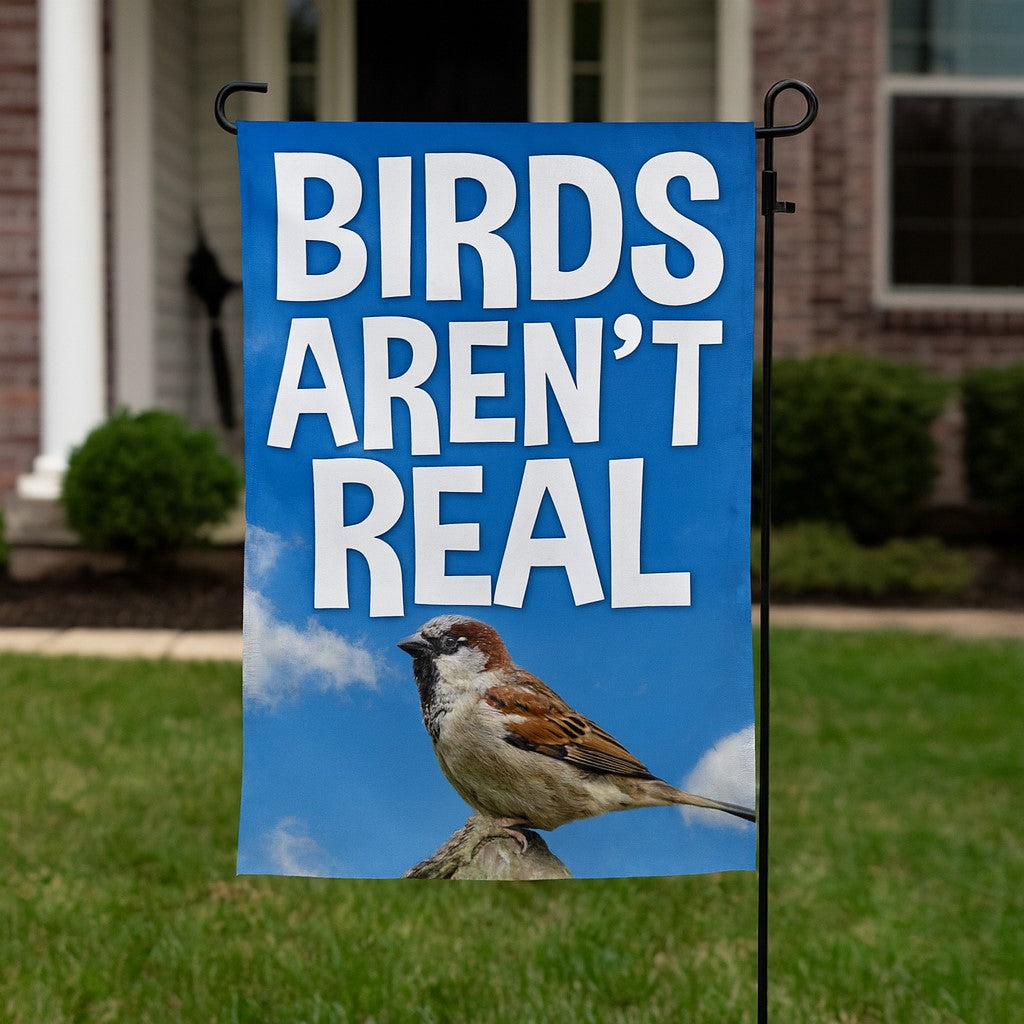 Garden flag with a bird and text 'BIRDS AREN'T REAL' in front of a house.