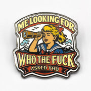 Enamel pin with a design of a person looking through a spyglass and text on a white background